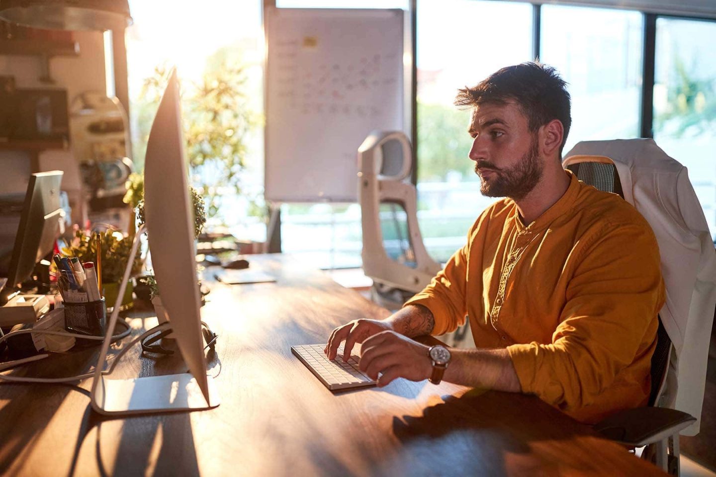 Business owner working at his desk staring at a computer screen